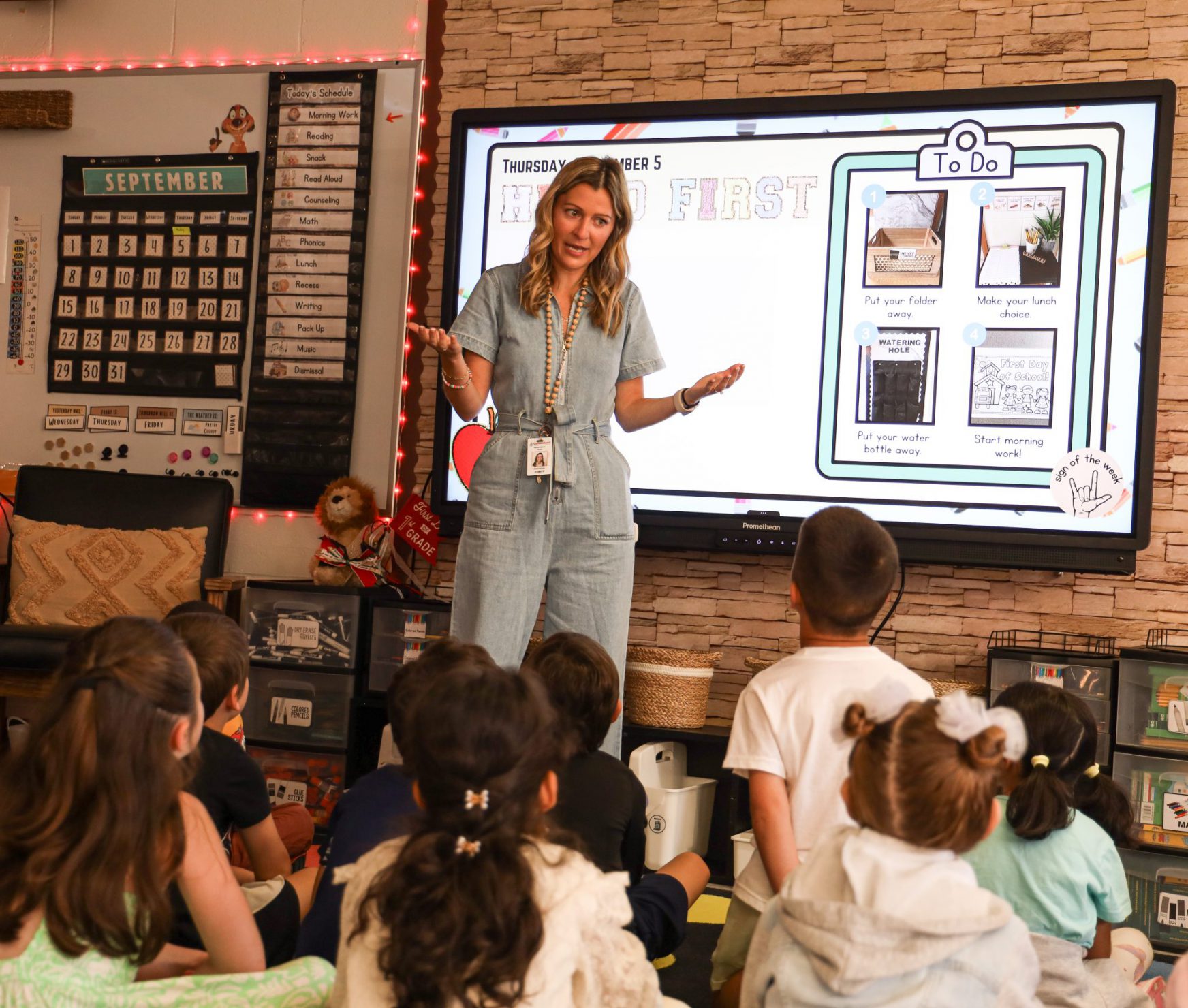 Teacher standing in front of classroom teaching students.