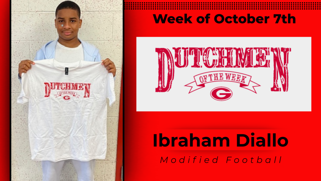 Student smiling holding up Dutchmen of the Week shirt. 