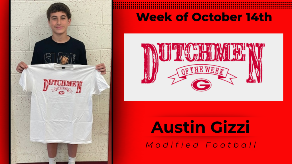 Student smiling and holding up Dutchmen of the Week shirt.