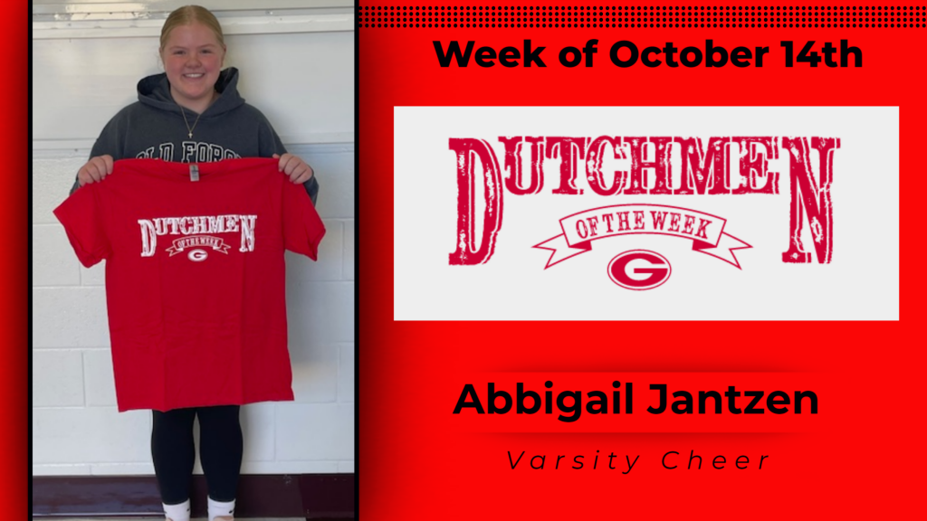 Student smiling and holding up Dutchmen of the Week shirt.