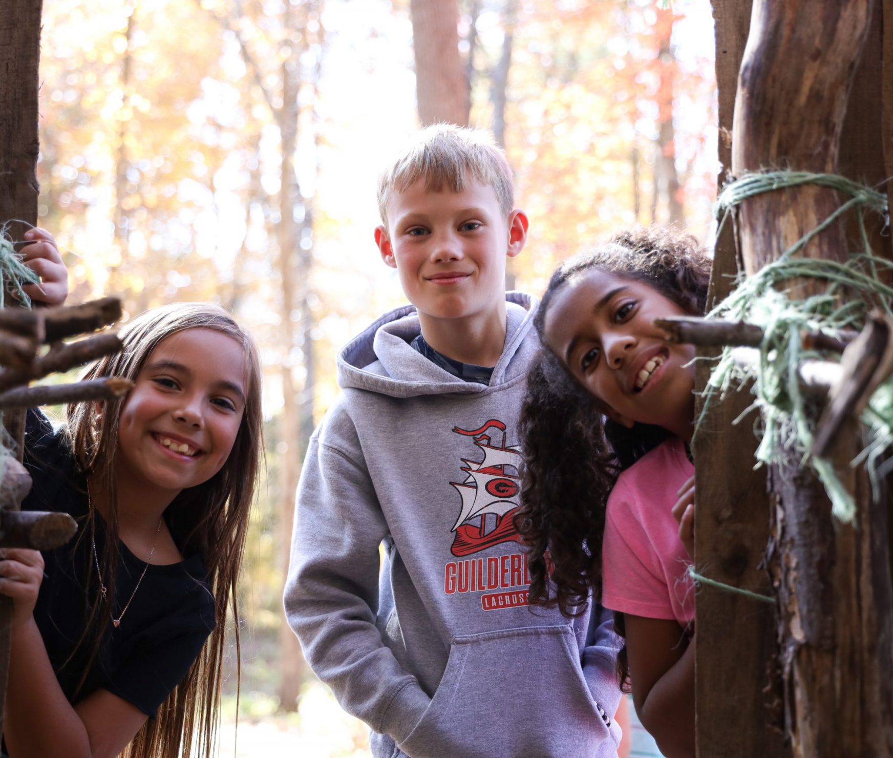 Lynnwood students smiling outside of an Iroquois longhouse.