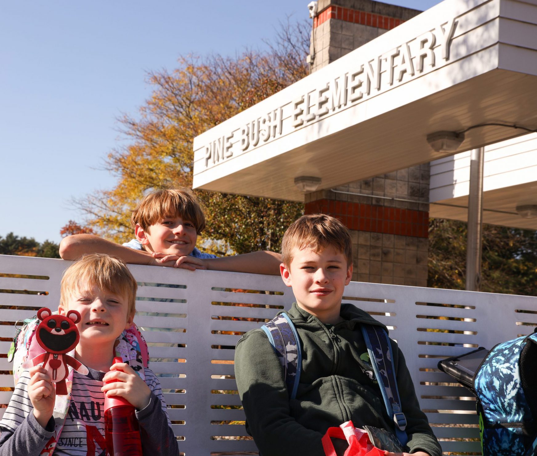 PBES students sitting in front of school.