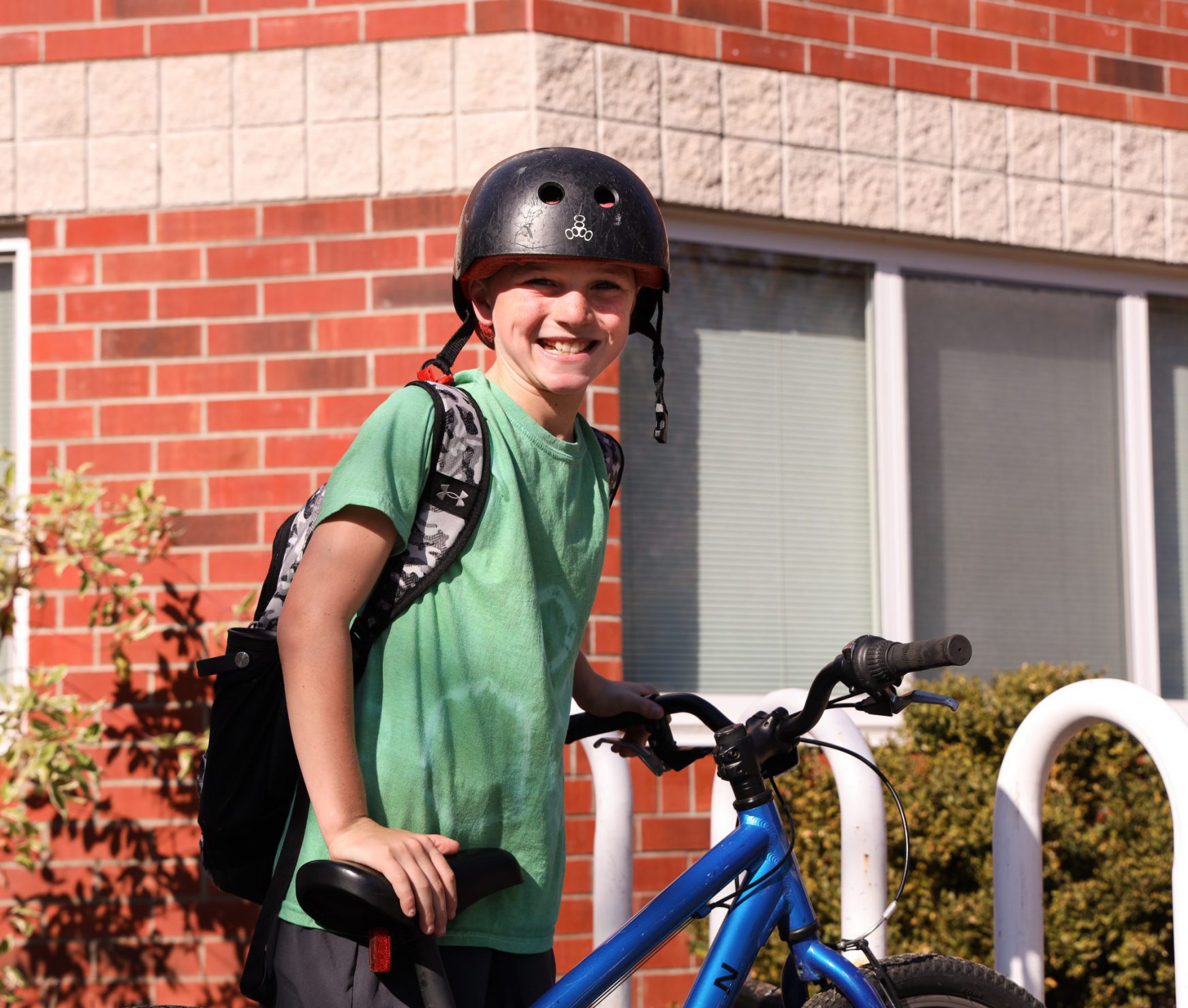 Student standing next to bike.