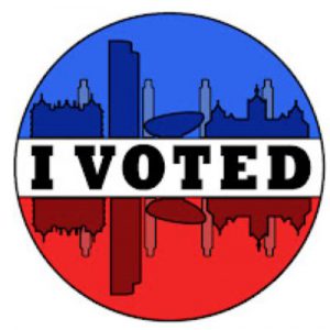 Round sticker that depicts the Albany skyline as mirror images. I VOTED is the horizon. One skyline is blue and one skyline is red