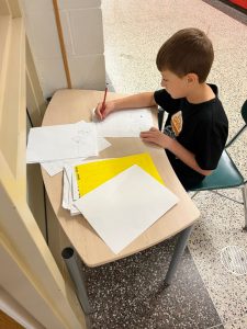 Elementary student working on an art project.