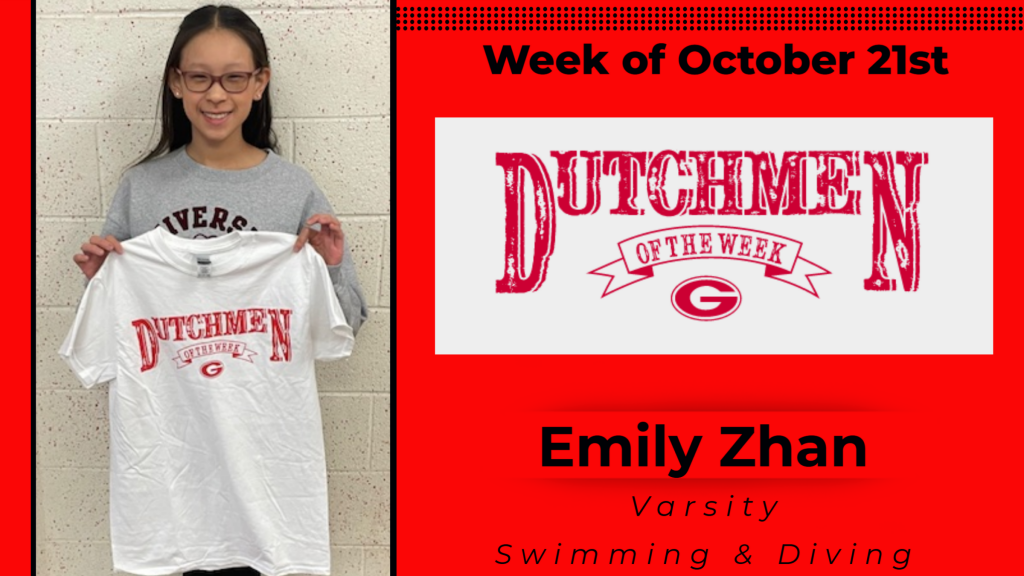 Student smiling and holding a Dutchmen of the Week shirt up for a photo.