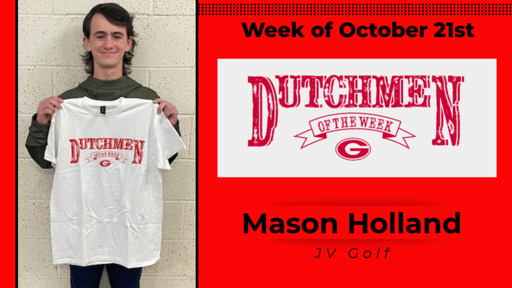 Student smiling and holding a Dutchmen of the Week shirt up for a photo.