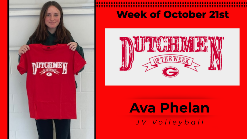 Student smiling and holding a Dutchmen of the Week shirt up for a photo.