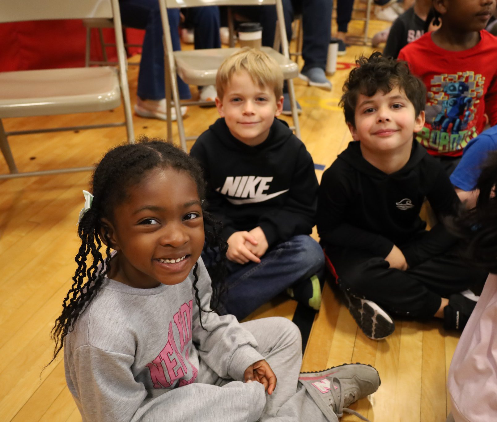 Elementary students smiling and gathering for assembly at WES.