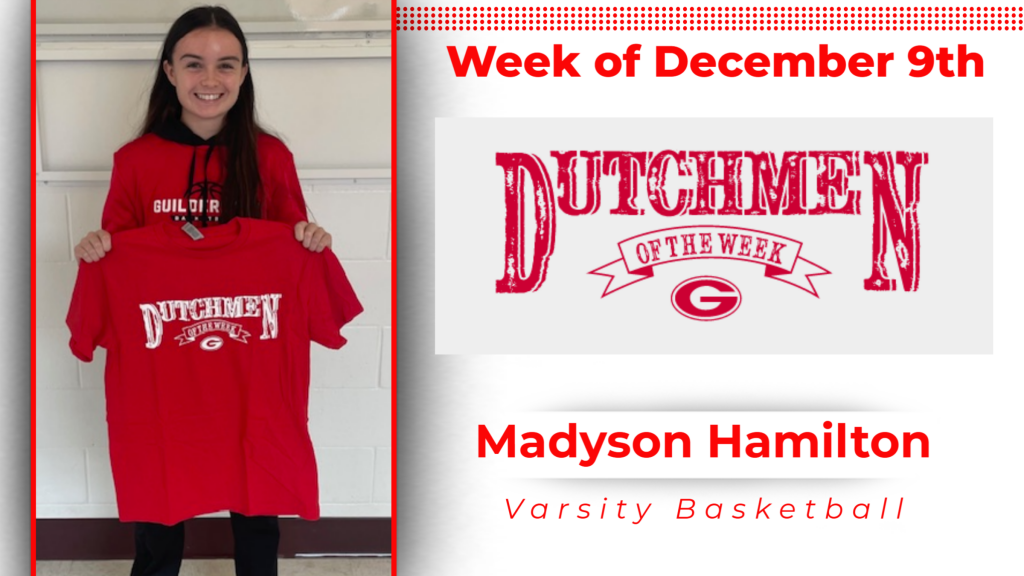 student smiling and holding up Dutchmen of the Week shirt.