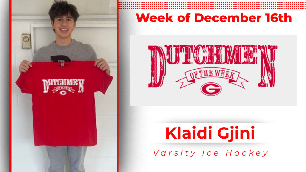 student smiling and holding up Dutchmen of the Week tshirt.