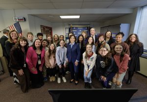 A group of GCSD students, teachers, administrators and board members stand with the governor at FMS