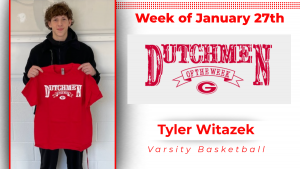 A student stands in front of a white wall holding a red t-shirt with white type that reads Dutchmen of the Week