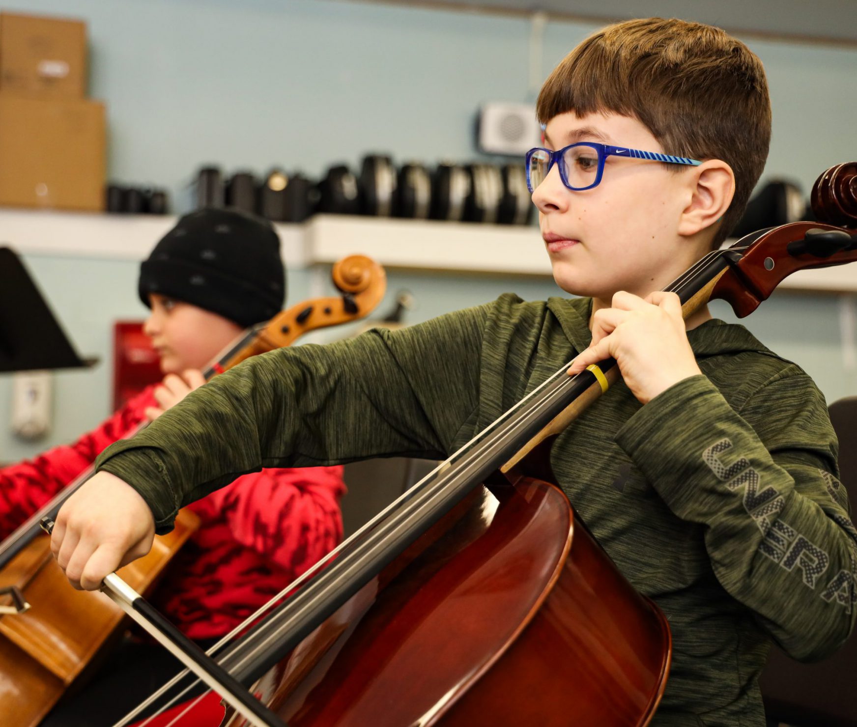 Student playing an instrument during a music lesson.