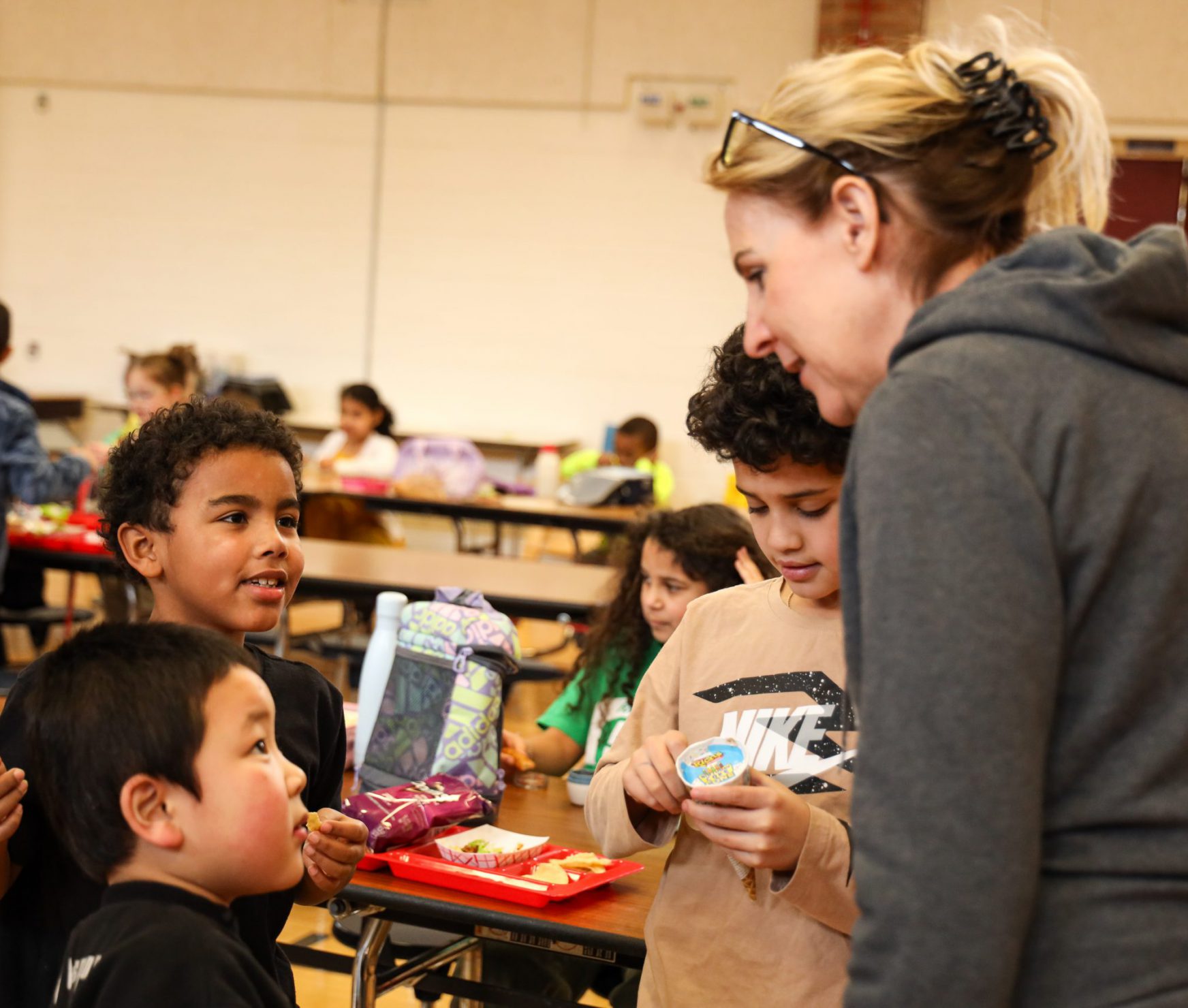 Students smiling at the lunch monitor.